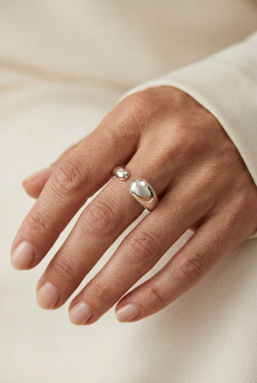 Close-up of a model wearing the open silver teardrop ring