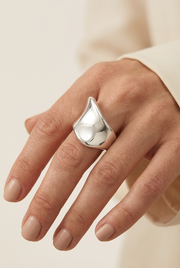 Close-up of a model wearing the sculptural silver ring