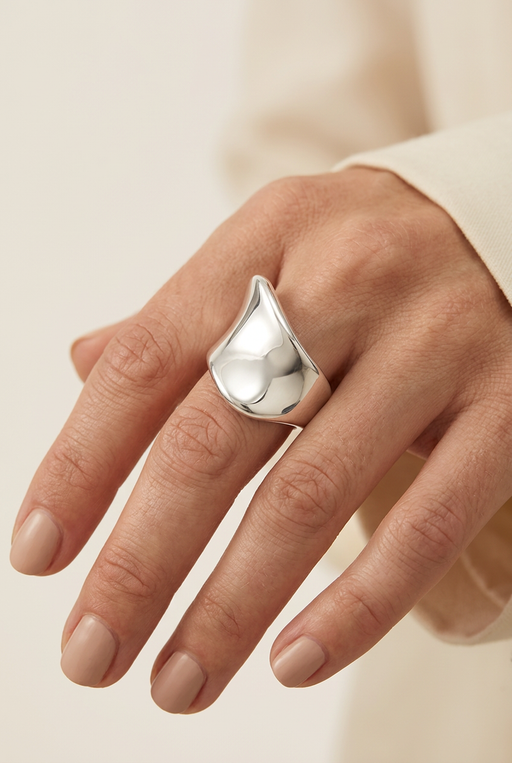 Close-up of a model wearing the sculptural silver ring