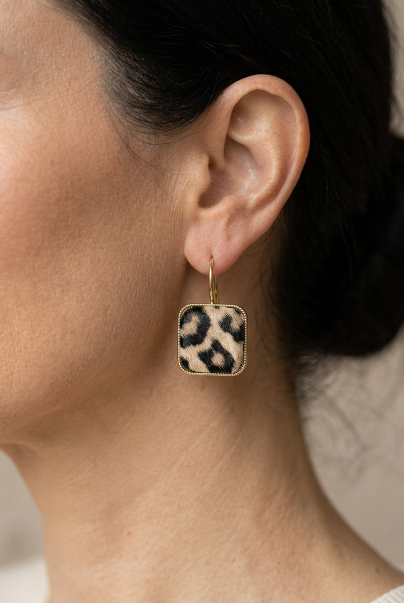 Closer view of the ear with a smaller leopard-print earring