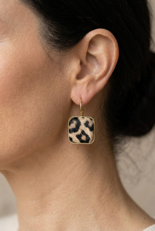 Closer view of the ear with a smaller leopard-print earring