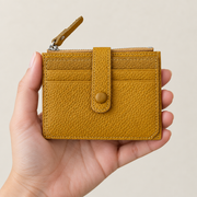 Hand holding the mustard wallet
