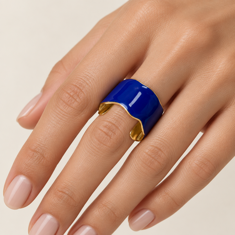 Model’s hand wearing the cobalt blue and gold ring