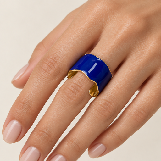Model’s hand wearing the cobalt blue and gold ring
