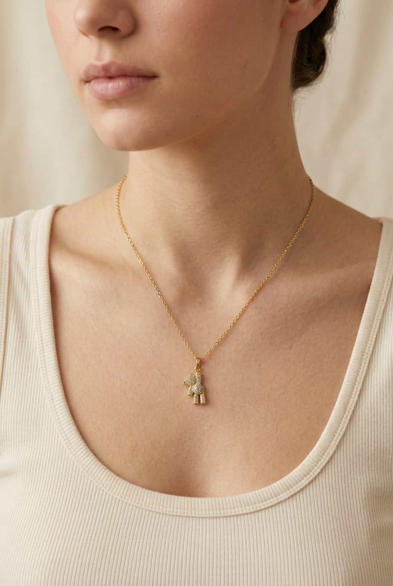 Model wearing the necklace with a much smaller bear pendant