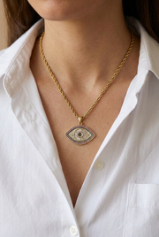 White-shirt necklace close-up with a smaller eye pendant