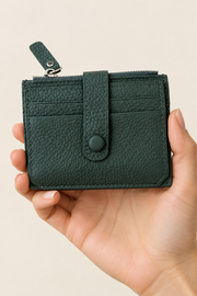 Woman’s hand holding your green wallet