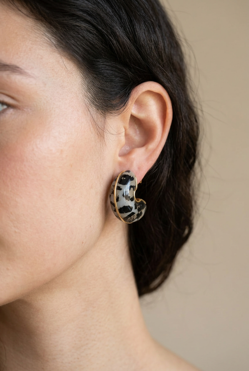 Young adult model wearing the spotted crescent earrings in close-up